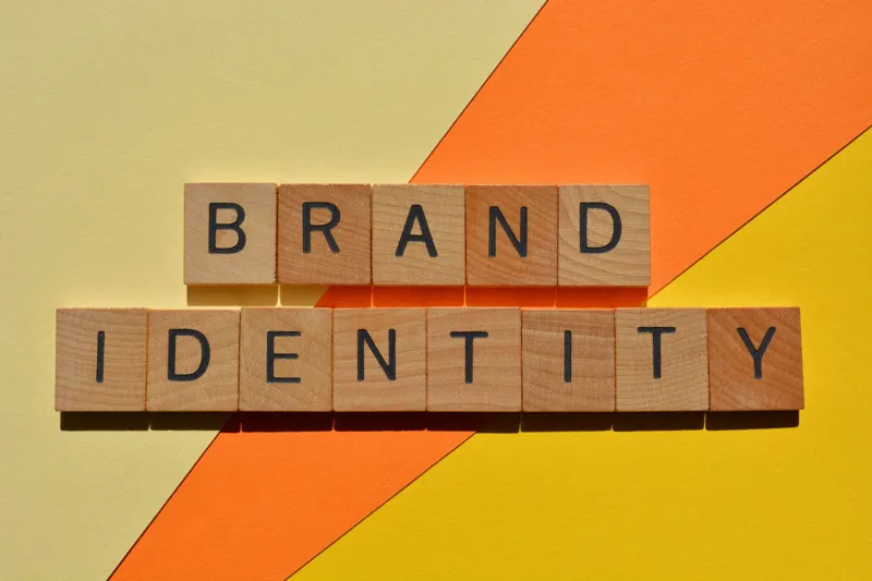 The words brand identity spelled in wooden block letters, illustrating a cohesive brand identity
