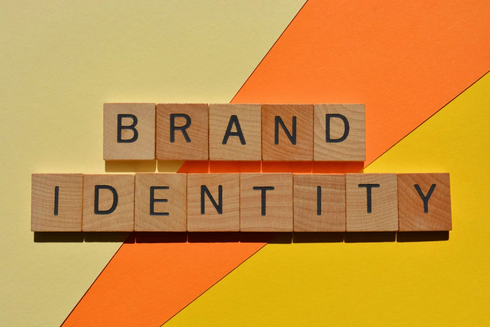 The words brand identity spelled in wooden block letters, illustrating a cohesive brand identity